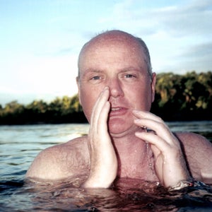 Patrick Symmes is notorious for traveling to conflict-prone areas around the globe. Here, he swims in Brazil's Xingu River.