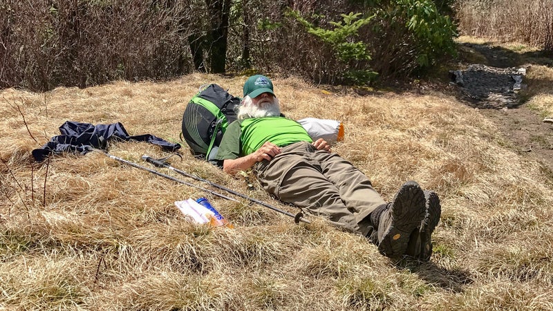 Sanders rests alongside the trail.