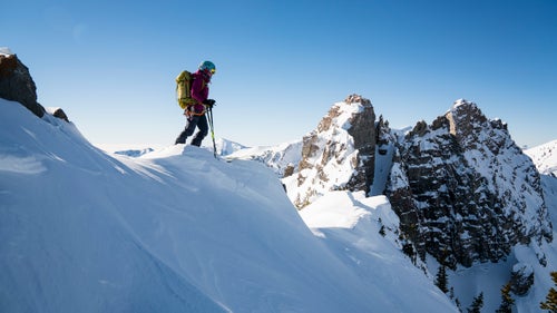 For the past five years, I’ve been working on a personal project to ski all 90 lines listed in Andrew McLean’s The Chuting Gallery, a skiing-climbing guidebook for Utah’s Wasatch Range. To my knowledge, I am the fourth person and first woman to complete the project. The routes described demand a wide range of skills: endurance for long vertical approaches, trad climbing, top-level ice climbing techniques, and the ability to make controlled ski turns in steep terrain.
A project of this magnitude was possible only because it’s in my backyard. Many of the Wasatch peaks are visible from the Salt Lake Valley and provide a true sufferfest minutes from a major metropolitan center. This season, I decided to focus my efforts on ticking off every last line in the book. I love the challenge the book provided, and I’m grateful for all the partners who shared these experiences with me.
Here, a look back at some of my favorite lines during the project.
Getting ready to drop into the Devil’s Castle Couloir at Alta. Surprisingly, this was one of the tricker lines in the book to ski, despite its relatively easy access. It’s very steep, and for how high and north facing it is, the snow doesn’t stay soft for long. It took me several tries to successfully ski this one.