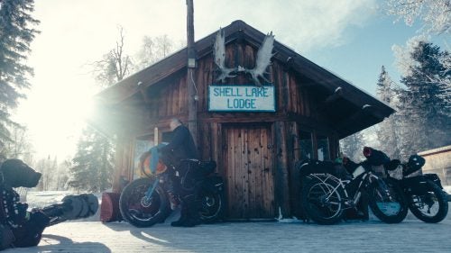 Along the trail, various shelters, cabins, and roadhouses offered an opportunity to get out of the cold, grab a bite to eat, and even a warm place to sleep. Here at Shell Lake Lodge, Frank Janssens unpacks gear he plans to dry inside in the early days of the race.