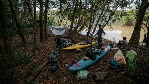 On April 11, kayaker Jules Domine stretches at the bank of the river while Aniol Serrasolses sits behind him. Also on the expedition was Chris Korbulic, a professional paddler and photographer and Stookesberry’s long-time paddling partner, and Jesse Rice, an American competitive kayaker who had recently guided in Chile.