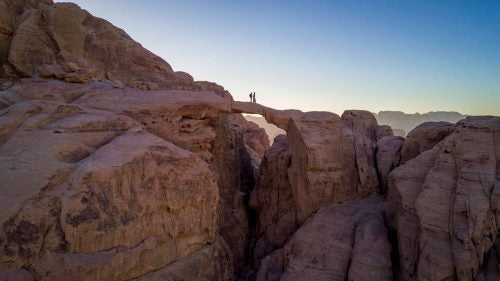 Hussein and Omer taking a moment on Burdah Arch, near Wadi Rum.