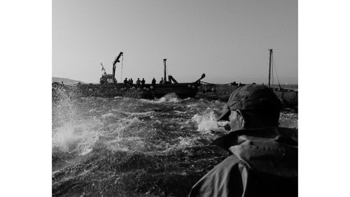 On the captain’s signal, the boats form into a corral, roughly 300 feet apart, known as the cuadra. The men assemble at the nets, pulling, heaving, and shouting as the walls slowly slide closer together and the whole system is pulled upward. Without warning, the sea goes from dead calm to absolutely boiling—bluefin break the surface in a crush of panic, thrashing and jumping while the space between the boats shrinks by the minute.