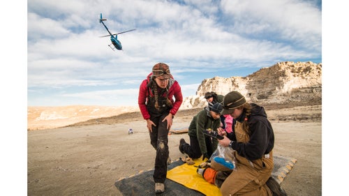 The capture crew heads off to net more deer as biologists Anna Ortega (left) and Katey Huggler (right) begin collecting data. It’s essential that the biologists work as quickly as possible to minimize stress on the animal.