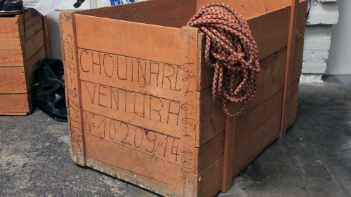 Kernmantle Rope Spool Crates
These crates date back to the early 1970s. They came from Switzerland packed with spools of kernmantle rope, which Chouinard Equipment employees would measure into lengths of 150 and 165 meters and sell as individual climbing ropes. The empty crates were apparently scattered about the growing headquarters and, as a free source of wood, repurposed into tables, benches, or office shelving. Julio Varela remembers assembling the crates into a kind of outdoor kitchen for the pig roasts he would host behind the Tin Shed.
To former Patagonia sales director Ric Hatch, the crate became a gift box of sorts. He had saved all of his samples from his years with the company (1979 to 2004) but couldn’t bring himself to toss or sell them. “I don’t know,” says Hatch, “I had an intuition that old clothing might have historical value. I just kind of kept all this stuff. I had an old Chouinard wooden crate that ropes came over from Europe in, and I just piled it all in there and brought it over to Val and Terri at the archives. Now they have it, and I have nothing except the greatest appreciation from Val.”