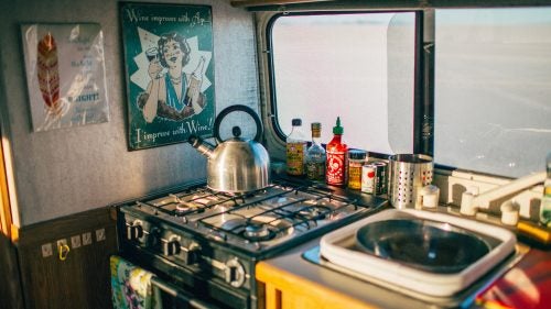 The Bigfoot trailer kitchen has a sink, gas stove, fridge, and even an oven. “I splurged on nonbreakable cookware so you can, like, whack people with a plate and it won’t shatter.”