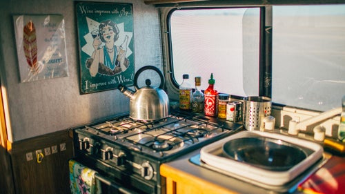 The Bigfoot trailer kitchen has a sink, gas stove, fridge, and even an oven. “I splurged on nonbreakable cookware so you can, like, whack people with a plate and it won’t shatter.”