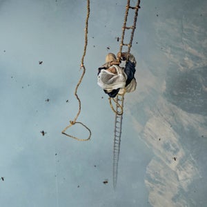Mauli Dhan climbs 100 feet up a bamboo rope ladder to his prize: a hive filled with neurotoxic honey. Image from the July issue of National Geographic magazine.