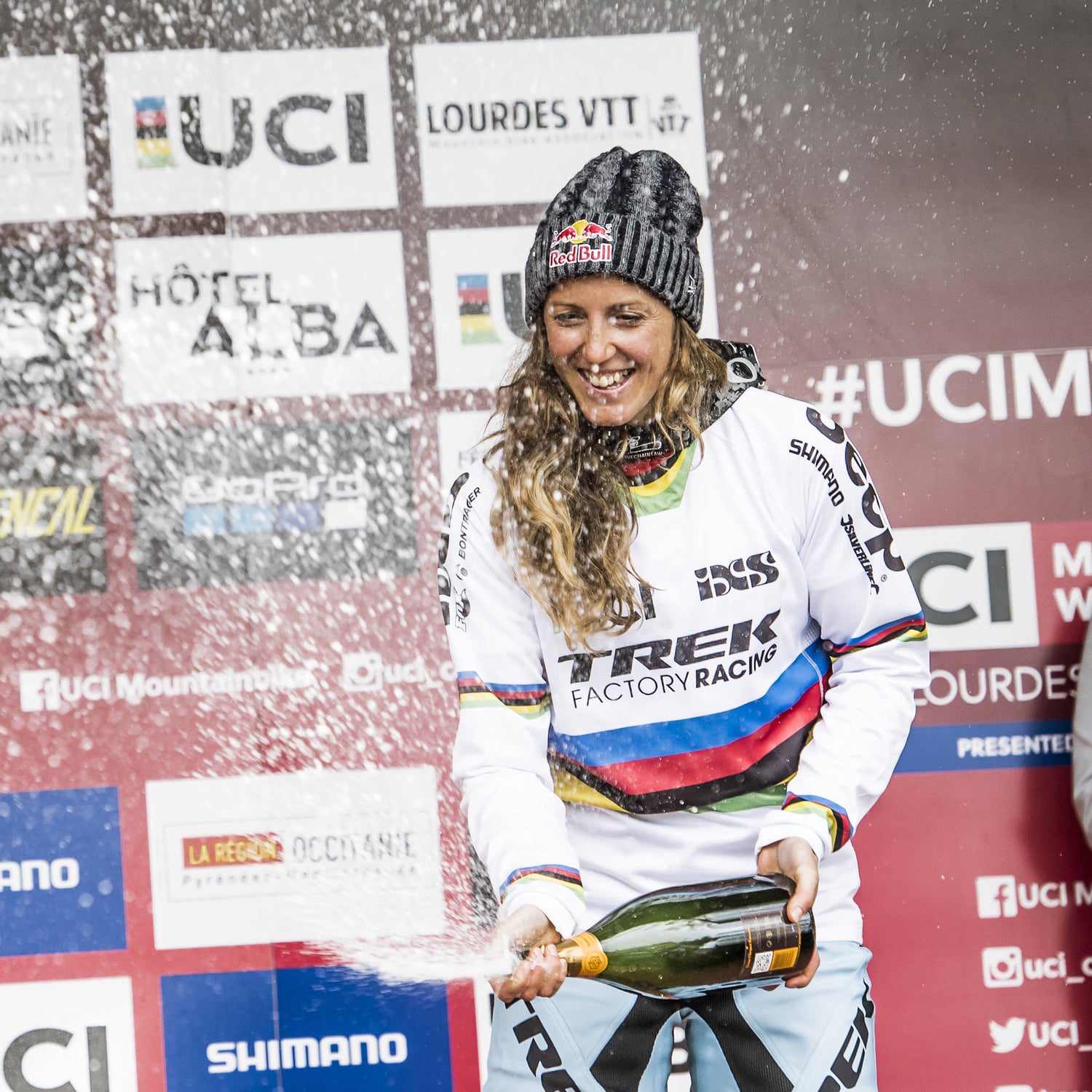Rachel Atherton stands on the podium at UCI DH World Cup in Lourdes, France.