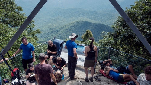 THE APPALACHIAN TRAIL, NEAR FRANKLIN, NORTH CAROLINA – 08/21/2017: Hikers and tourists congregate at Albert Mountain Fire Tower on the Appalachian Trail, on the center line of the path of eclipse totality. Hundreds of walkers and day-trippers walked into the woods at Albert Mountain to witness a total eclipse. Forest Rangers closed entrance roads and monitored numbers trying to access the Fire Tower denying access to the area as the number of spectators grew through the day. CREDIT: Spike Johnson for Outside Magazine.