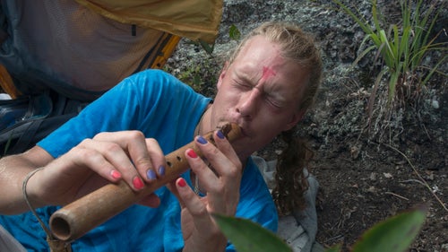 THE APPALACHIAN TRAIL, NEAR FRANKLIN, NORTH CAROLINA – 08/21/2017:
Bjorn Parramoure, 31, from Gainesville, Florida waits for the solar eclipse beneath Albert Mountain Fire Tower along the Appalachian Trail in North Carolina. He’s camped at Albert Fire Mountain, on the centerline of eclipse totality to wait for the event. With a homemade recorder he welcomes the eclipse. CREDIT: Spike Johnson for Outside Magazine.