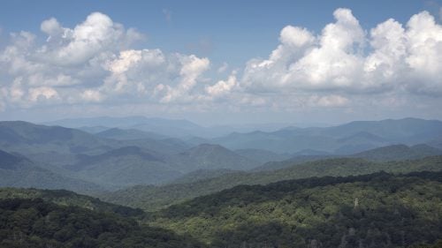 THE APPALACHIAN TRAIL, NEAR FRANKLIN, NORTH CAROLINA – 08/21/2017: Green forest rolls away from Albert Mountain Fire Tower on the Appalachian Trail, on the center line of the path of eclipse totality. August’s full solar eclipse is the first visible from the United States since 1979. Traveling over 14 states on its way east, from Oregon to South Carolina, the eclipse passes over the southern end of the Appalachian Trail - a 2,200-mile wilderness hike that winds from Georgia to Maine. CREDIT: Spike Johnson for Outside Magazine.