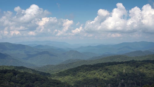 THE APPALACHIAN TRAIL, NEAR FRANKLIN, NORTH CAROLINA – 08/21/2017: Green forest rolls away from Albert Mountain Fire Tower on the Appalachian Trail, on the center line of the path of eclipse totality. August’s full solar eclipse is the first visible from the United States since 1979. Traveling over 14 states on its way east, from Oregon to South Carolina, the eclipse passes over the southern end of the Appalachian Trail - a 2,200-mile wilderness hike that winds from Georgia to Maine. CREDIT: Spike Johnson for Outside Magazine.