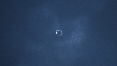 THE APPALACHIAN TRAIL, NEAR FRANKLIN, NORTH CAROLINA – 08/21/2017: During the 2 minutes, 45 seconds of total eclipse, a faint halo could be seen pushing through thin clouds. August’s full solar eclipse is the first visible from the United States since 1979. Traveling over 14 states on its way east, from Oregon to South Carolina, the eclipse passes over the southern end of the Appalachian Trail - a 2,200-mile wilderness hike that winds from Georgia to Maine. CREDIT: Spike Johnson for Outside Magazine.