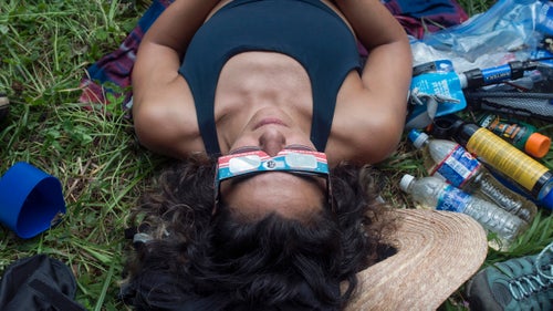 THE APPALACHIAN TRAIL, NEAR FRANKLIN, NORTH CAROLINA – 08/21/2017: Yalda Jam, 32, who has traveled from Houston, Texas, waits at Albert Mountain to watch the solar eclipse pass over the Appalachian Trail. Albert Mountain in North Carolina, marks the spot where the exact middle of the eclipse crosses the trail, and the turnaround point on Jam’s three-day out and back hike. “It’s been a special experience” she said “but knowing what I know now, I’d think carefully before attempting a longer hike.” CREDIT: Spike Johnson for Outside Magazine.