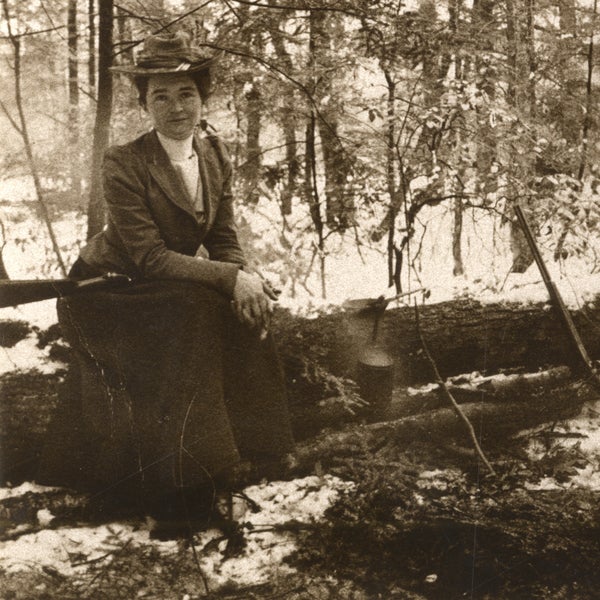 Hubbard poses on a log during an expedition.