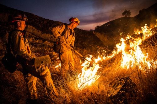 Fire Captain Brian Borba, left, and firefighter Brian Hanson keep an eye on a section of the Pocket Fire near Geyserville, California on October 13, 2017. As of Friday night, the Pocket Fire had burned more than 10,000 acres and was 5% contained.
