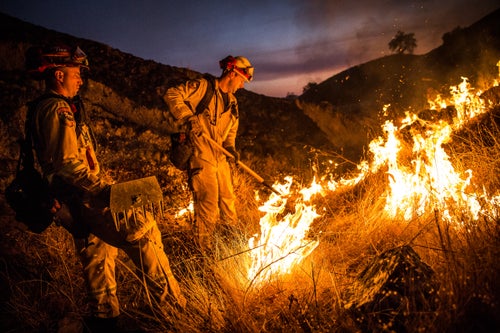 Fire Captain Brian Borba, left, and firefighter Brian Hanson keep an eye on a section of the Pocket Fire near Geyserville, California on October 13, 2017. As of Friday night, the Pocket Fire had burned more than 10,000 acres and was 5% contained.