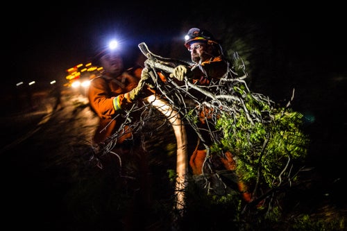 Members of the Intermountain inmate crew clear brush along a road ahead of the Pocket Fire near Geyserville, California on October 13, 2017. As of Friday night, the Pocket Fire had burned more than 10,000 acres and was 5% contained. an eye on a section of the Pocket Fire near Geyserville, California on October 13, 2017. As of Friday night, the Pocket Fire had burned more than 10,000 acres and was 5% contained.