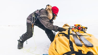 In rough ice, teams of two push, pull, and drag the pulks through.