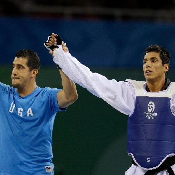 Steven Lopez (right) celebrates with his brother and coach Jean after a bronze medal match at the Beijing Olympics.