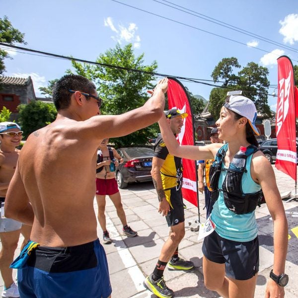 Runners high-five after one of China's growing number of races.