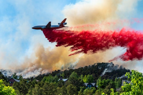 July 4th, 4:45: PM: After loading what I can into my truck (art, photos, a table I built by hand), two friends show up panting, ready to help. “We have to go now,” they say. Slurry bombers join the helicopters create an aerial ballet above town taking turns dropping red fire retardant just above us. We watch from my front door, mesmerized as first crop-dusters do their runs, then twin engines planes and even jets ending with a DC-10 (Photo), strafing just a few hundred feet over my neighbors rooftops to the north.