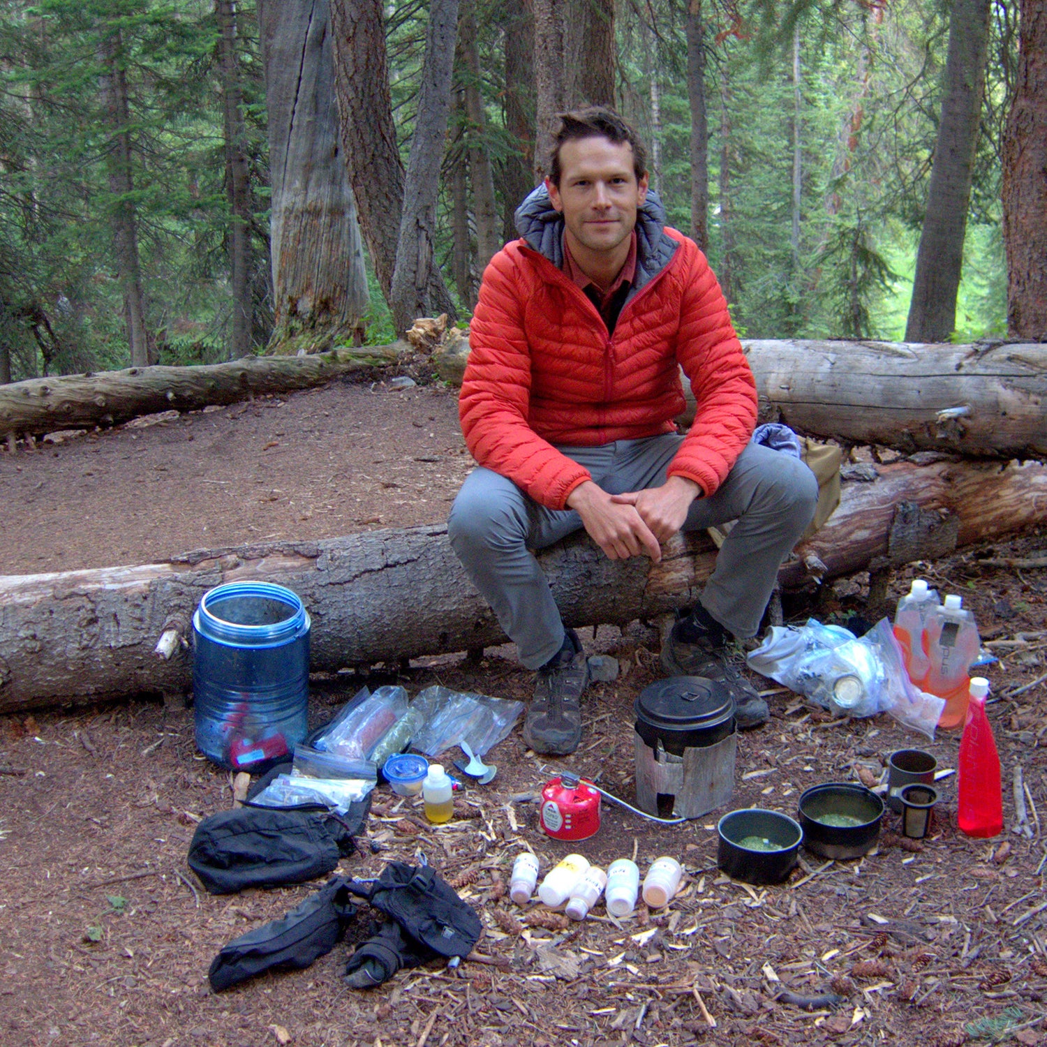 The author preparing dinner, with his trusty bear canister nearby.