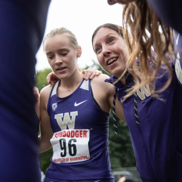 Maurica Powell, University of Washington’s director of track and field and cross country, consults her athletes.