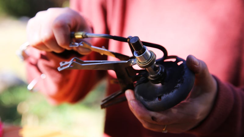 Carefully slide the fuel generator loop back on the stove.