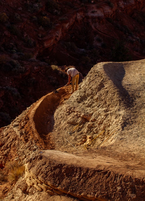 A digger builds a berm with a steep cliff behind it, leading into a huge drop. Small build pieces are often just as important as the lips and landings, as flowing from feature to feature is key to maintaining speed.