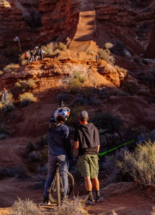 Brandon Semenuk discusses the course with a friend after a practice run.