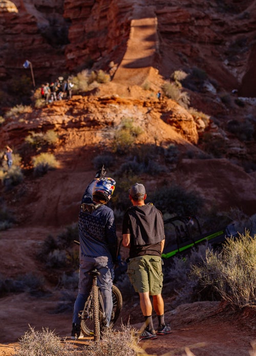 Brandon Semenuk discusses the course with a friend after a practice run.