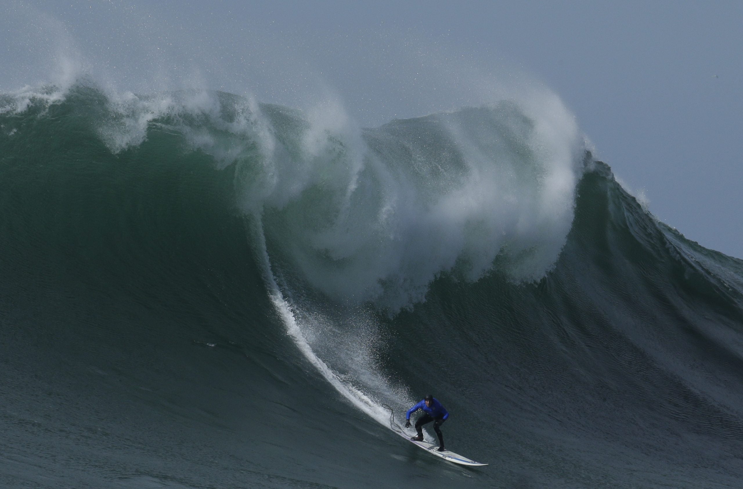 In this Friday, Feb. 12, 2016 file photo Travis Payne rides a giant wave during the finals of the Mavericks surfing contest in Half Moon Bay, Calif.