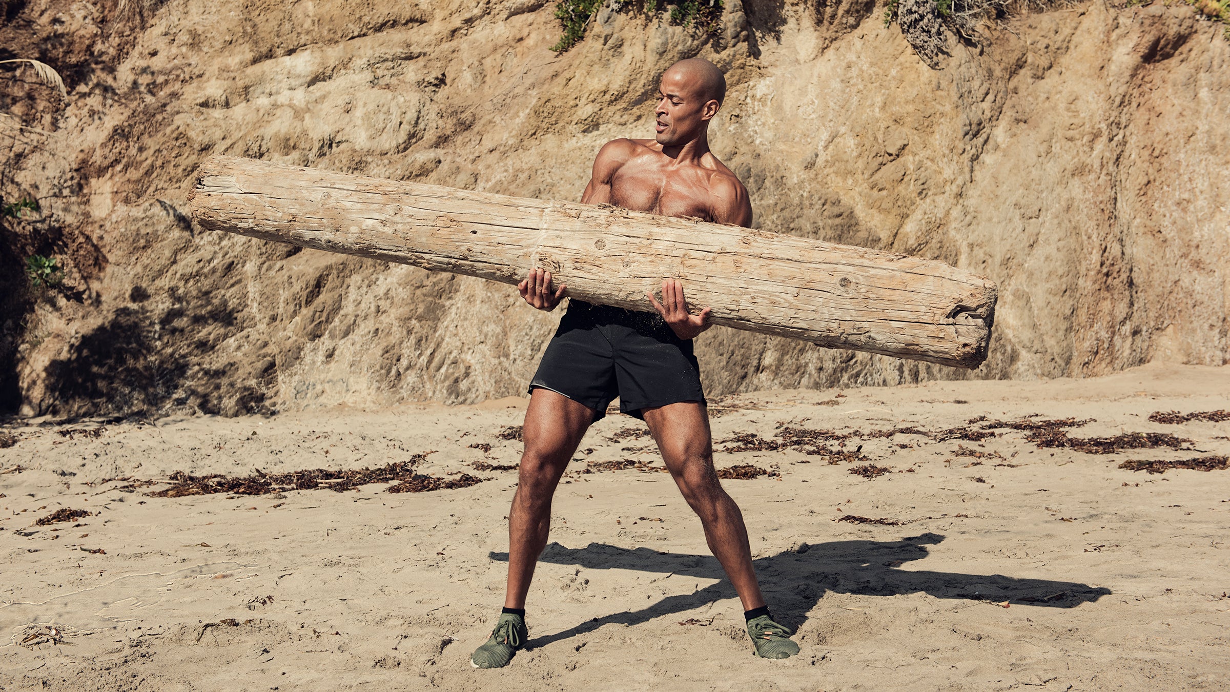 David Goggins on the Beach Lifting a Large Piece of Driftwood David Goggins on the Beach Lifting a Large Piece of Driftwood