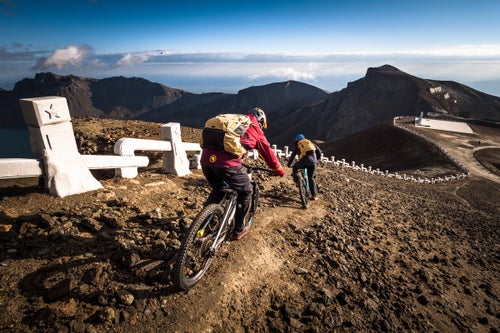 On a little-trodden trail, Philipp and Schumann descend alongside Paektu’s crater rim towards a gleaming white granite monument. North Korea’s supreme leaders have historically made speeches to the nation from Paektu, underpinning the mountain’s importance in North Korean politics and propaganda. Two weeks after riding Paektu, Kim Jong-Un and South Korean president Moon Jae-in would raise clasped hands at this monument.