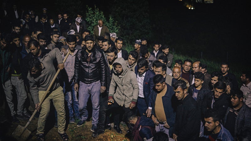 Kurdish men attend the funeral of landmine victim Haidar Shwan.