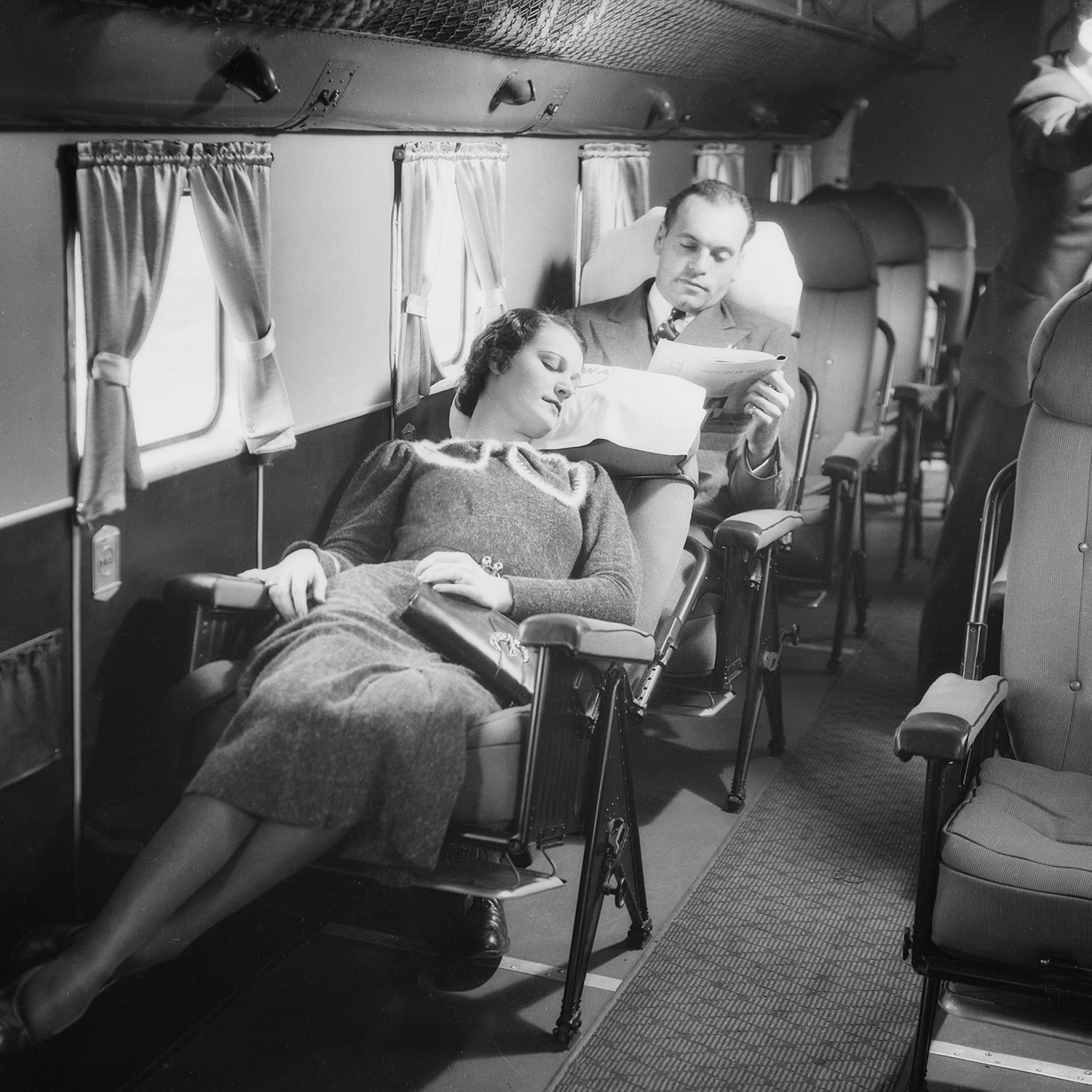 A customer reclines in the cabin of a Transcontinental and Western Air Douglas DC-1 Airplane.
