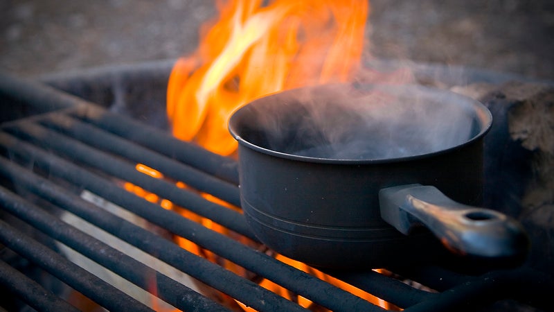 Hot water before bedtime can help keep you warm all night. Bringing a hot-water bottle to bed, or throwing one in your sleeping bag ahead of time, will prime your system for warmth all night. And a hot cup of tea or cocoa can raise your body temperature before turning in.