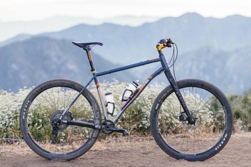 You might expect to see a heavyweight like this bombing downhill on a 35-pound enduro rig with six inches of suspension, but here again Cummins goes against convention. He is the world’s most unlikely retro-grouch. A brand ambassador for Niner bikes, all six of his bikes are 29-inch hardtails, and most of them are singlespeeds. Not a single one has a dropper post. When he sees my full-suspension ride, he good-naturedly calls it a “robot bike.”