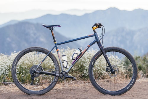 You might expect to see a heavyweight like this bombing downhill on a 35-pound enduro rig with six inches of suspension, but here again Cummins goes against convention. He is the world’s most unlikely retro-grouch. A brand ambassador for Niner bikes, all six of his bikes are 29-inch hardtails, and most of them are singlespeeds. Not a single one has a dropper post. When he sees my full-suspension ride, he good-naturedly calls it a “robot bike.”