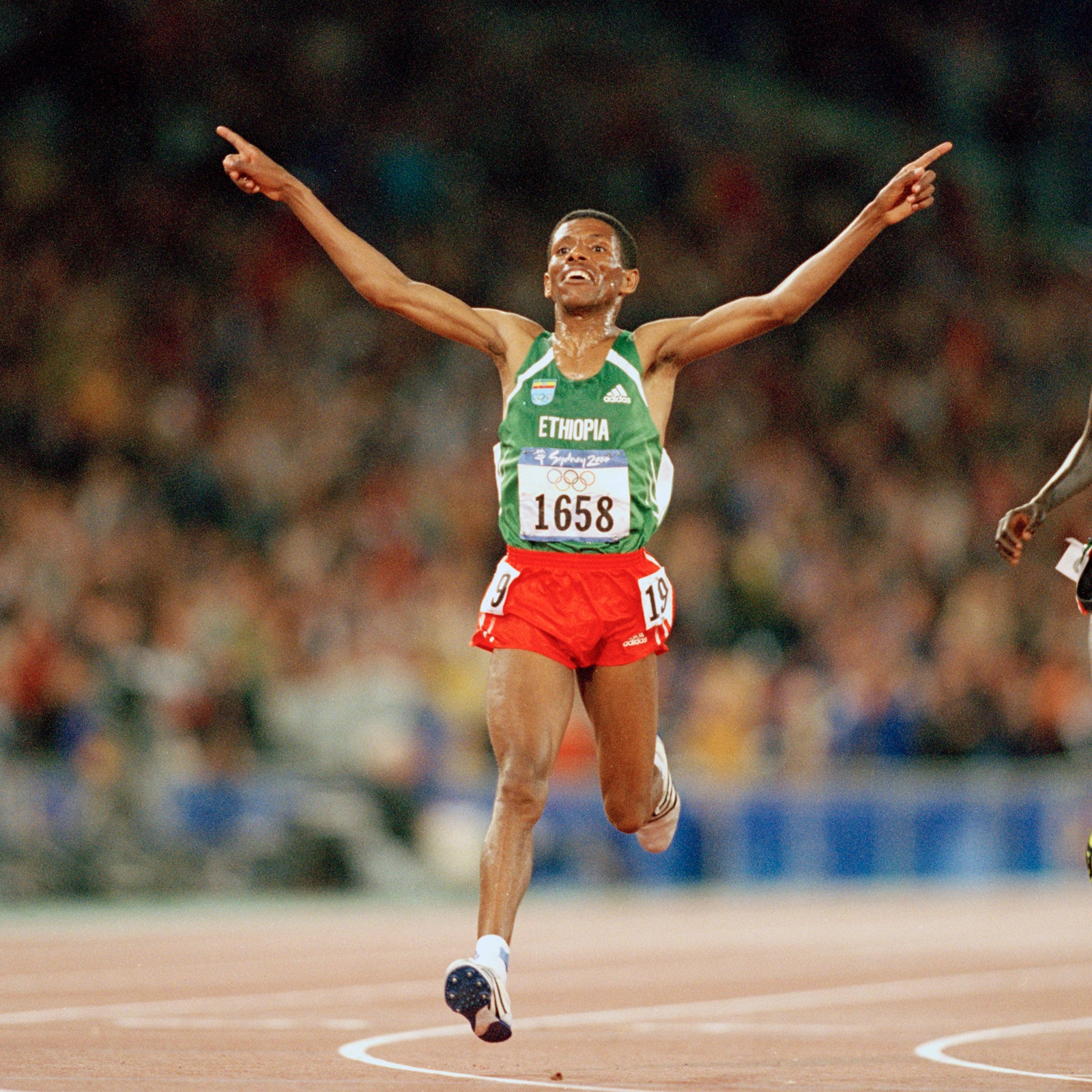 Haile Gebrselassie reaches the finish line of the 10,000 metres at the Sydney Olympics in 2000.