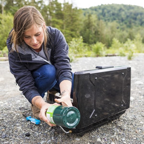 Woman setting camping stove