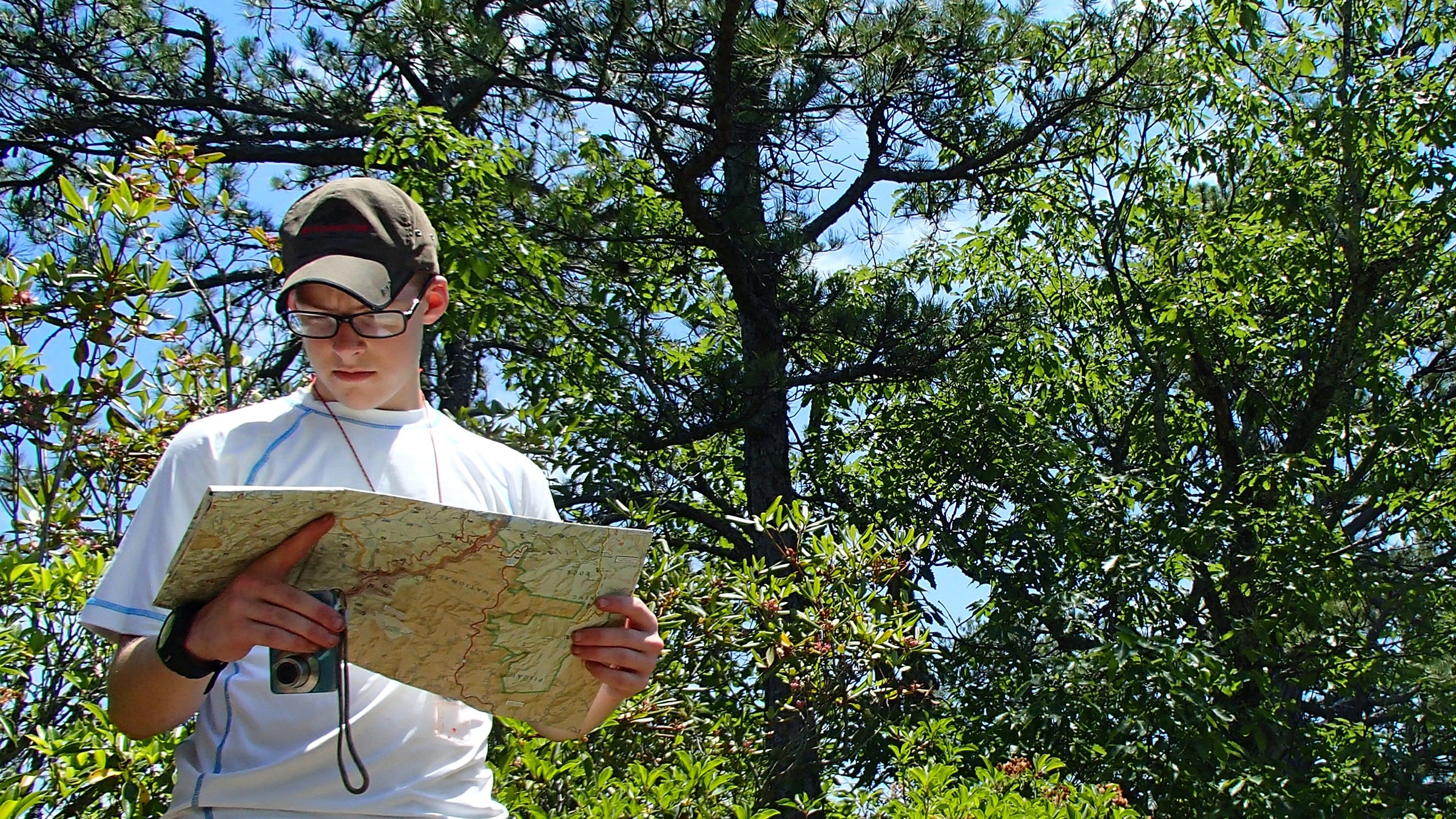 Man in the woods with map