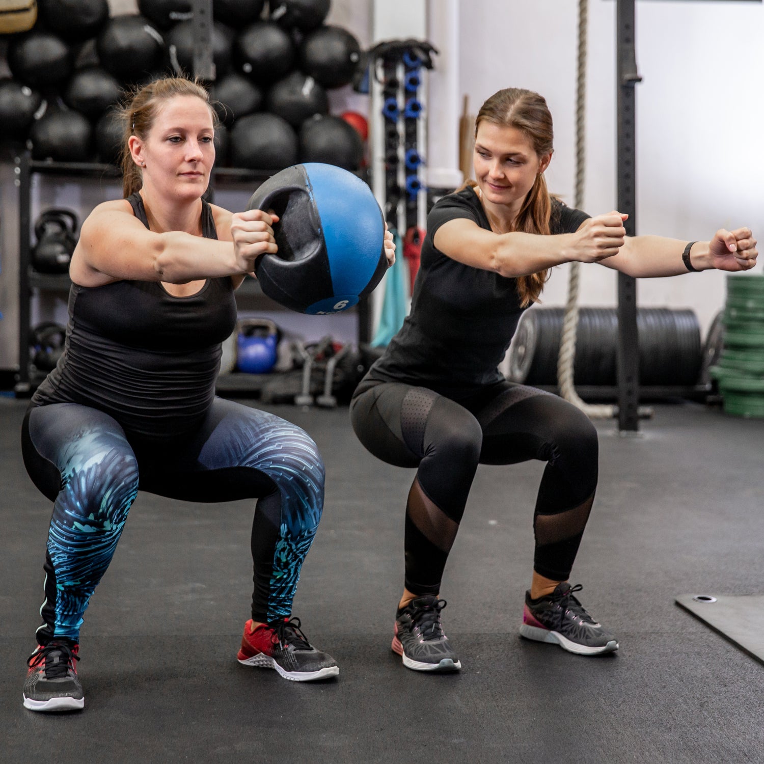 Pregnant Woman Doing Weight Exercise With Fitness Instructor