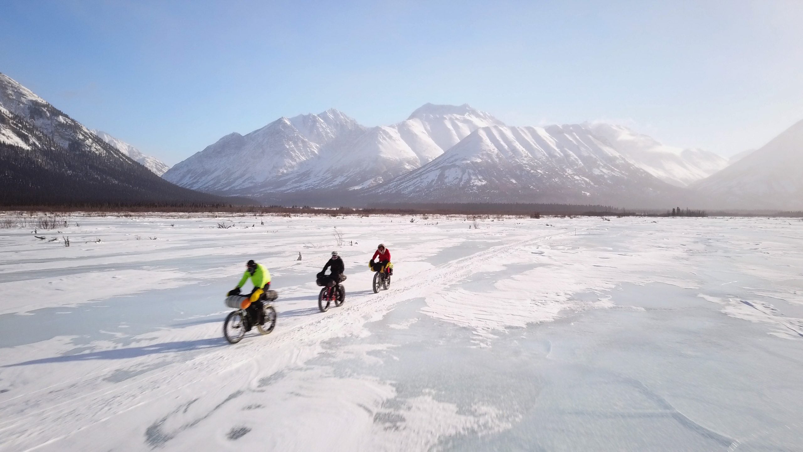 Three riders cross the Kuskokwim River after leaving the Rohn checkpoint during the Iditarod Trail Invitational.