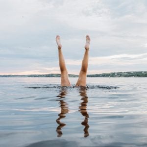 Swimmer Doing Handstands In The Water