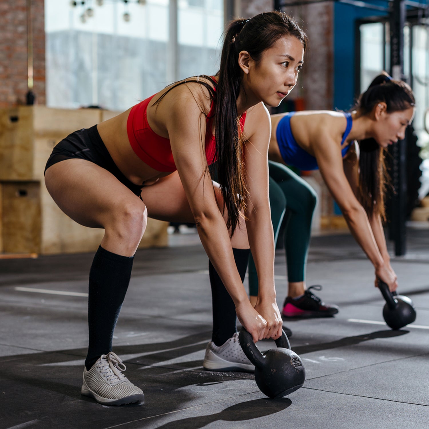 Asian Woman Lifting Weights In Gym