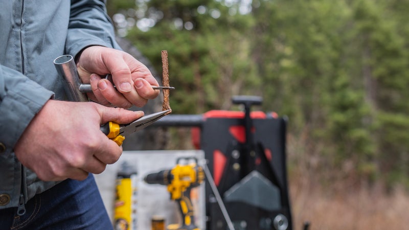 Getting the plug through the eyelet can be fussy. These things are designed to be difficult to remove from a hole, not easy to insert into one. The pliers will help.