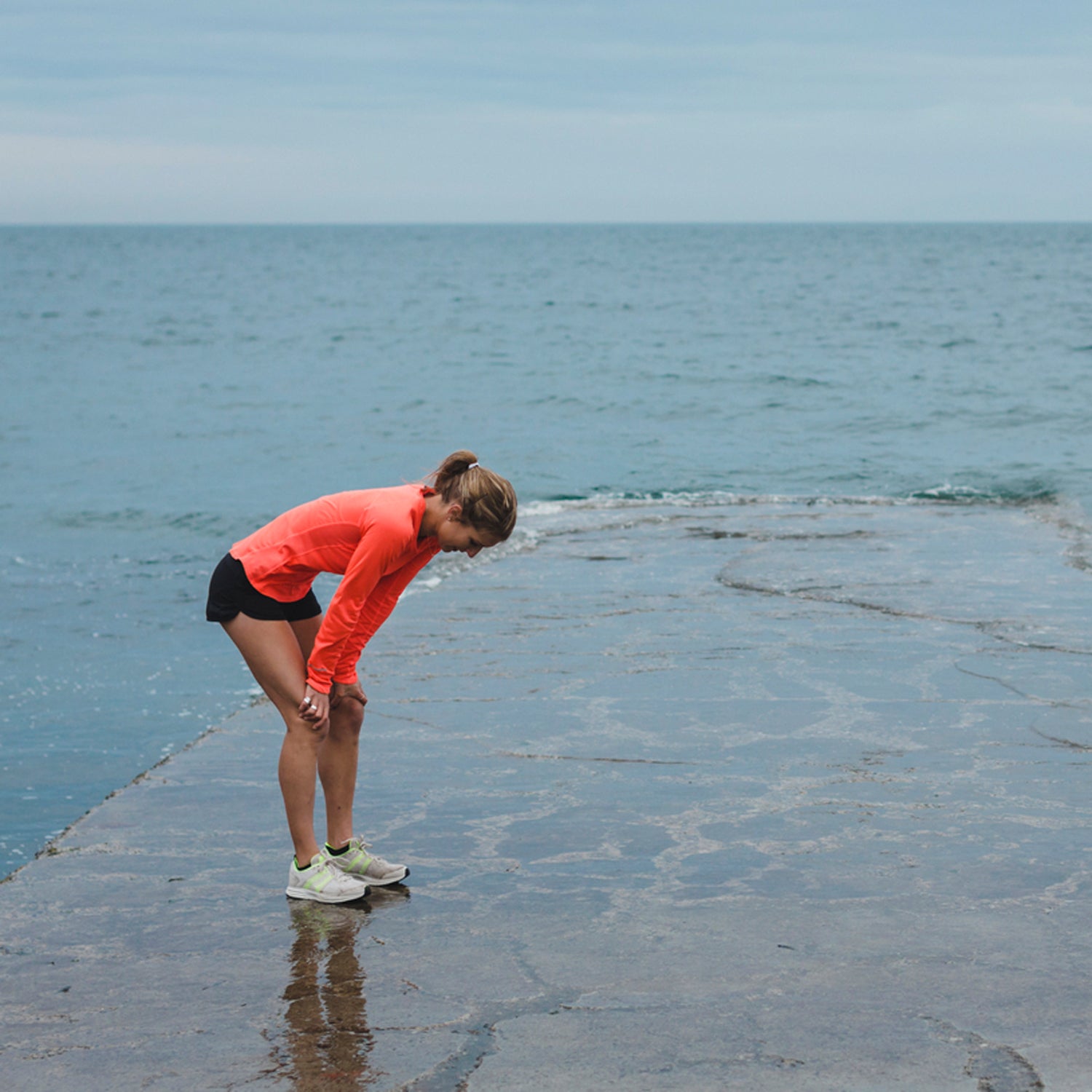 Motivated Young Runner Woman Breathing Hard Outside On Cold Windy Day